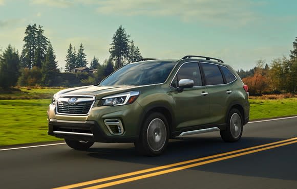 A green 2019 Subaru Forester on a country road.