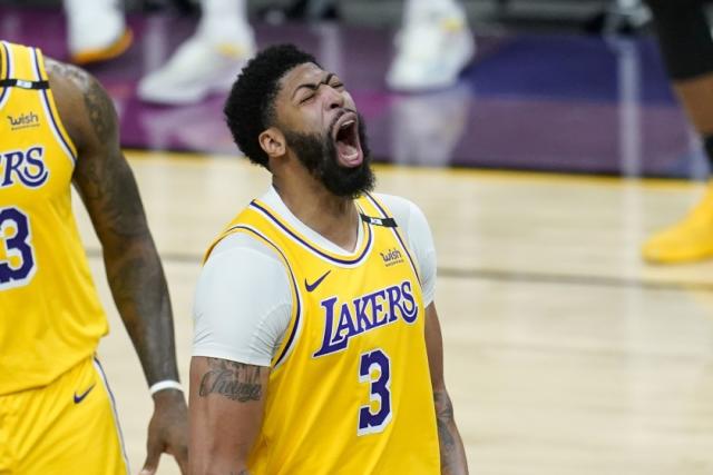Los Angeles Lakers forward Anthony Davis shouts as he celebrates a stop against the Phoenix Suns during the second half of Game 2 of an NBA basketball first-round playoff series Tuesday, May 25, 2021, in Phoenix. The Lakers defeated the Suns 109-102. (AP Photo/Ross D. Franklin)