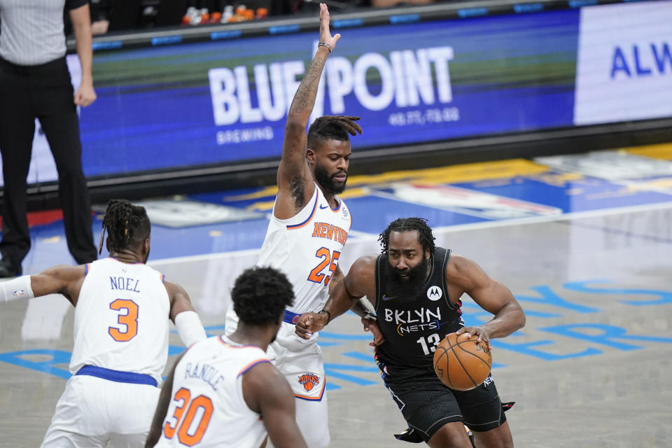 Brooklyn Nets' James Harden (13) drives past New York Knicks' Reggie Bullock (25) during the first half of an NBA basketball game Monday, April 5, 2021, in New York. (AP Photo/Frank Franklin II)