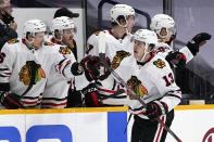 Chicago Blackhawks center Mattias Janmark (13) is congratulated after scoring a goal against the Nashville Predators in the second period of an NHL hockey game Tuesday, Jan. 26, 2021, in Nashville, Tenn. (AP Photo/Mark Humphrey)