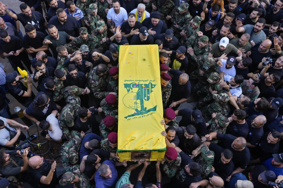 Hezbollah fighters carry the coffin of their comrade, Qassim Ibrahim Abu-Taam, who was killed along Lebanon's southern border with Israel, during his funeral procession in the southern Beirut suburb of Dahiyeh, Lebanon, Monday, Nov. 6, 2023. (AP Photo/Hassan Ammar)