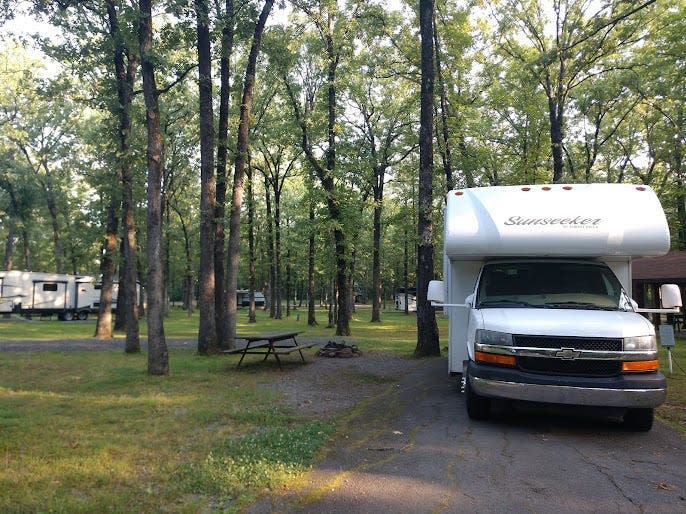 White RV parked in tree-filled area, Burns Park