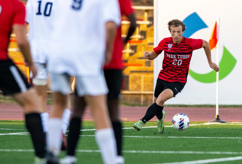 Park Tudor High School sophomore Elliot Scotten (20) moves the ball toward the goal box during the first half of an IHSAA Class A boys’ soccer State Championship match against Greenwood Christian Academy High School, Friday, Oct. 28, 2022, at IUPUI’s Michael A. Carroll Track and Soccer Stadium in Indianapolis.