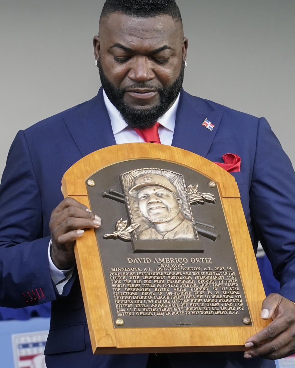 Hall of Fame inductee David Ortiz, formerly of the Boston Red Sox, holds his plaque during the National Baseball Hall of Fame induction ceremony, Sunday, July 24, 2022, at the Clark Sports Center in Cooperstown, N.Y. (AP Photo/John Minchillo)