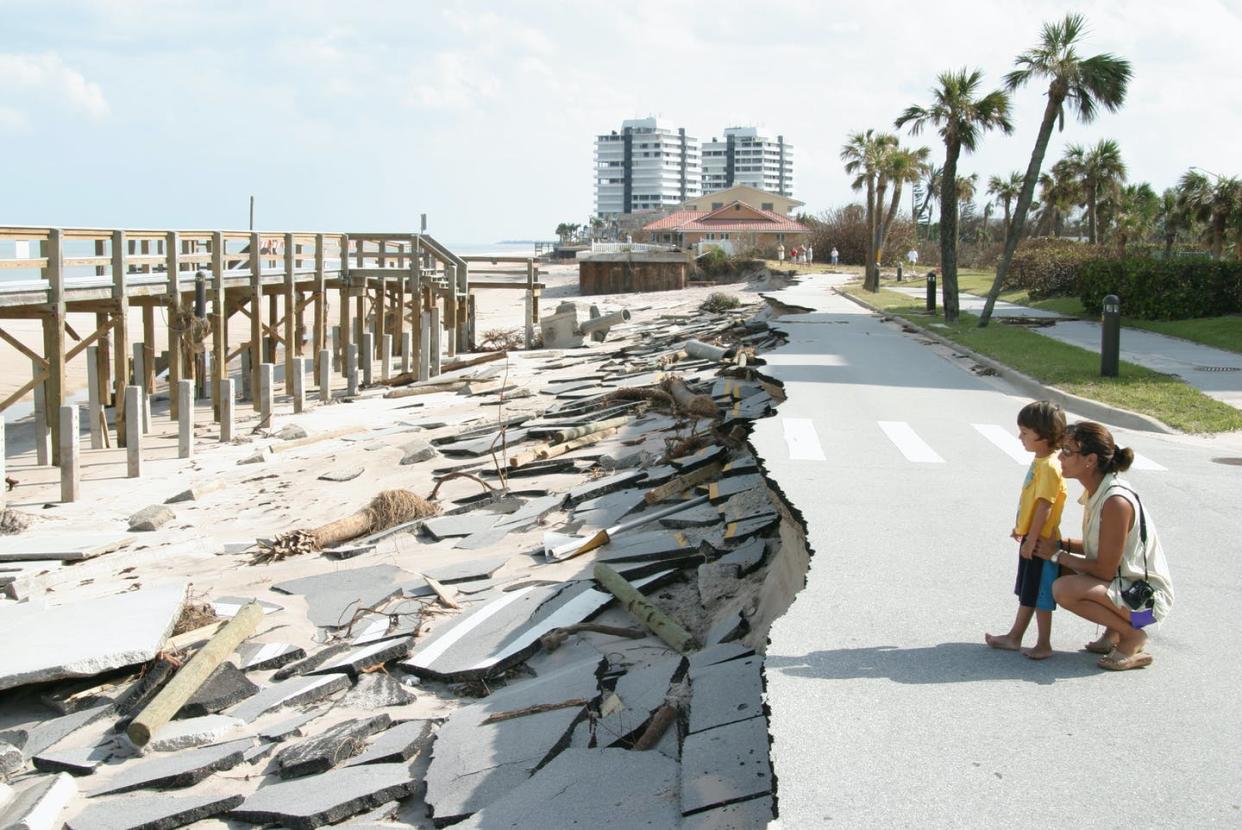 <span class="caption">A lot of coastal infrastructure wasn't designed for the frequent flooding and crashing waves brought by rising seas. </span> <span class="attribution"><a class="link " href="https://www.gettyimages.com/detail/news-photo/mother-and-son-looking-at-the-missing-road-at-vero-beach-news-photo/929313998?adppopup=true" rel="nofollow noopener" target="_blank" data-ylk="slk:Jeffrey Greenberg/Universal Images Group via Getty Images;elm:context_link;itc:0;sec:content-canvas">Jeffrey Greenberg/Universal Images Group via Getty Images</a></span>