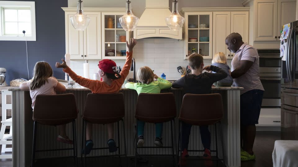 After playing outside, Peter Mutabazi serves his foster kids ice cream in their Charlotte, North Carolina, home. - Sean Mcinnis/The Charlotte Observer/Zuma