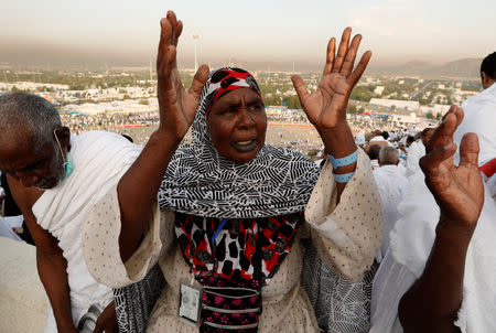 A Muslim pilgrim prays as she gathers with others on Mount Mercy on the plains of Arafat during the annual haj pilgrimage, outside the holy city of Mecca, Saudi Arabia August 20, 2018. REUTERS/Zohra Bensemra