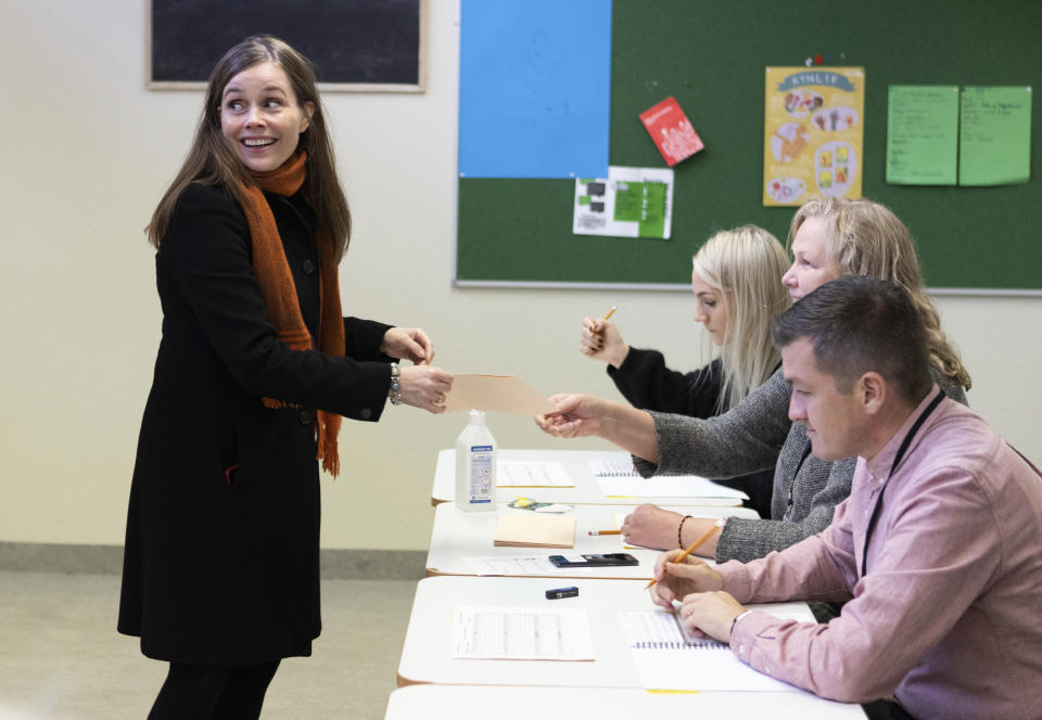 Iceland's Prime Minister Katrin Jakobsdottir casts her vote at a polling station in Reykjavik, Iceland, Saturday, Sept. 25, 2021. Icelanders are voting in a general election dominated by climate change, with an unprecedented number of political parties likely to win parliamentary seats. (AP Photo/Arni Torfason)