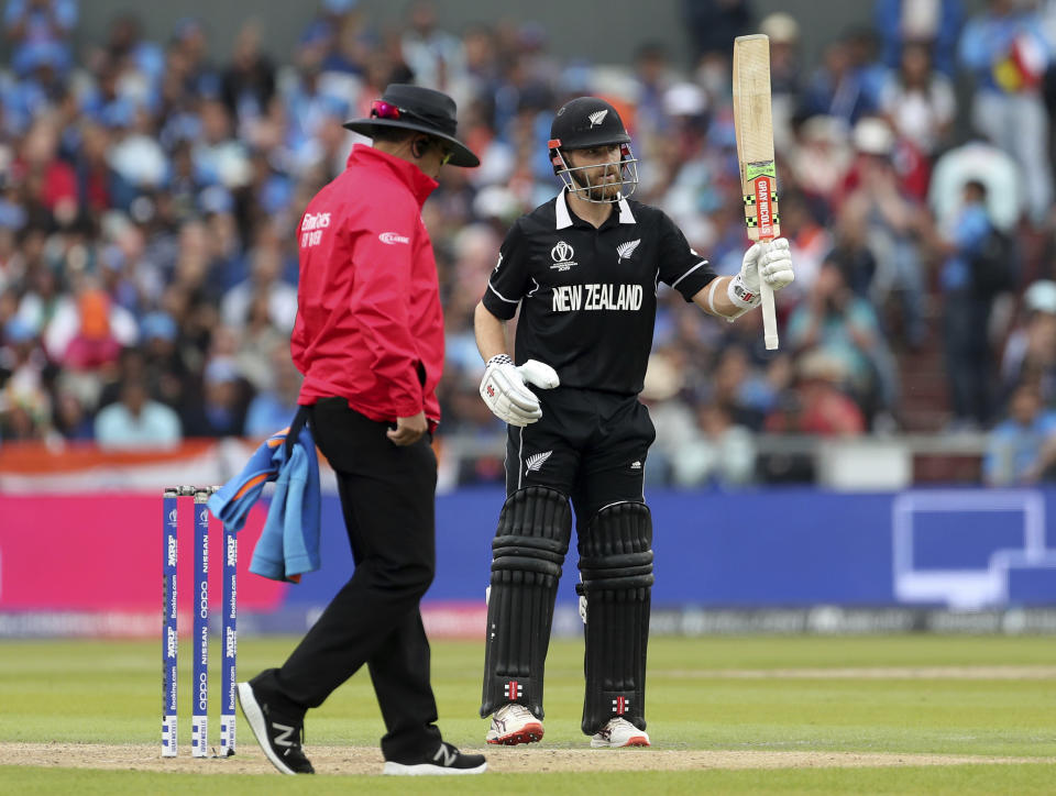 New Zealand's captain Kane Williamson, right, raises his bat to celebrate scoring fifty runs during the Cricket World Cup semi-final match between India and New Zealand at Old Trafford in Manchester, England, Tuesday, July 9, 2019. (AP Photo/Aijaz Rahi)