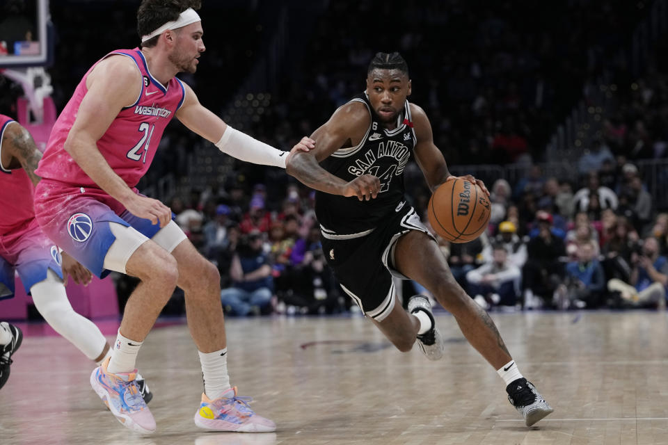 San Antonio Spurs guard Blake Wesley (14) drives around Washington Wizards forward Corey Kispert (24) during the second half of an NBA basketball game Friday, March 24, 2023, in Washington. (AP Photo/Carolyn Kaster)