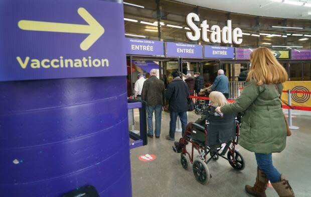 Seniors arriving Wednesday for their COVID-19 vaccination at a clinic in Olympic Stadium. (Paul Chiasson/The Canadian Press - image credit)