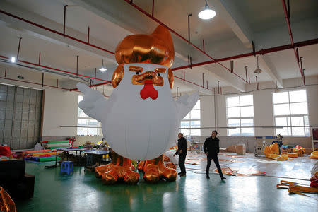 Workers show to visitors an inflatable chicken that local media say bears resemblance to U.S. President-elect Donald Trump as their factory braces for the Year of the Rooster in Jiaxing, Zhejiang province, China January 12, 2017. REUTERS/Aly Song