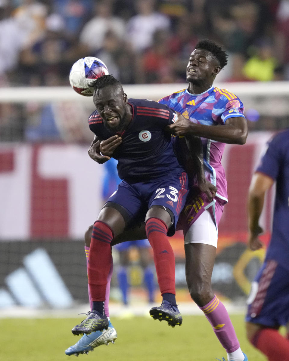 Toronto FC defender Aimé Mabika, right, holds back Chicago Fire forward Kei Kamara in the second half of an MLS soccer match Saturday, July 15, 2023, in Chicago. (AP Photo/Charles Rex Arbogast)