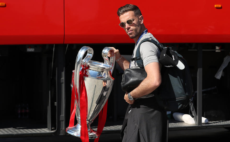 Liverpool captain Jordan Henderson leaves the Eurostars Madrid Tower Hotel with the Champions League trophy, as the team travel home for a homecoming parade.