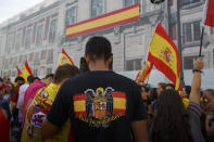 <p>An anti-separatist demonstrator wears a t-shirt with the image of the pre-constitutional Spanish flag during a protest in support of Spain’s unity as Catalonian votes in referendum on Oct. 1, 2017 in Madrid, Spain. (Photo: Pablo Blazquez Dominguez/Getty Images) </p>