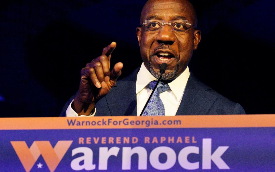 Reverend Raphael Warnock is also the Democrats' incumbent US senator - BOB STRONG/REUTERS