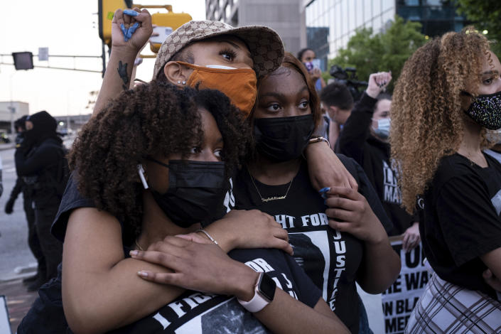 Chiara Campbell, from left, Nyasia Thompson and Jaylah Lesesne embrace following a march through downtown Atlanta after Derek Chauvin was found guilty of three counts in the death of George Floyd Tuesday, April 20, 2021. (AP Photo/Ben Gray)
