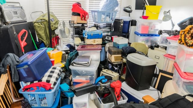 Room packed with stored boxes, electronics, files, business equipment and household items.