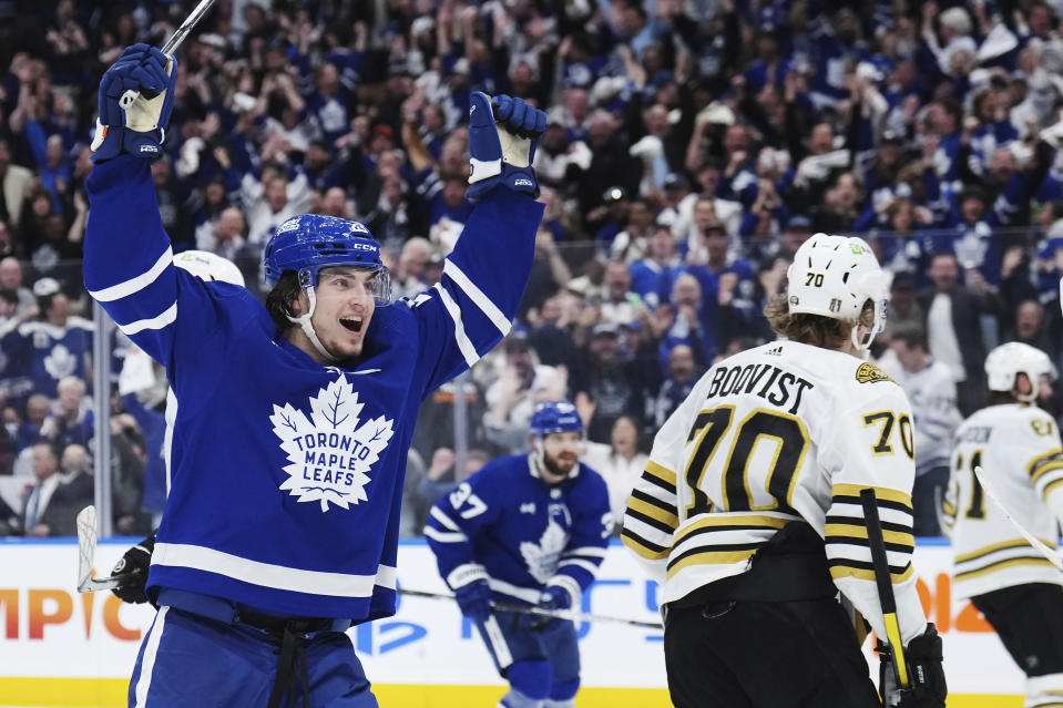 Toronto Maple Leafs' Matthew Knies, left, celebrates after a goal as Boston Bruins' Jesper Boqvist (70) skates by during second-period action in Game 6 of an NHL hockey Stanley Cup first-round playoff series in Toronto, Thursday, May 2, 2024. (Nathan Denette/The Canadian Press via AP)