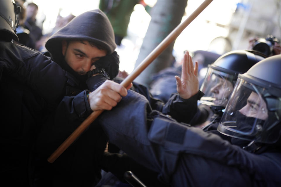 Police officers push back pro independence demonstrators during scuffles following a peaceful protest outside the Spain-France summit in Barcelona, Spain, Thursday, Jan. 19, 2023. A summit between the Spanish and French governments, led by their executive leaders, prime minister Pedro Sánchez and president Emmanuel Macron, is held in the capital of Catalonia to strengthen relations between the European neighbors by signing a friendship treaty. (AP Photo/Joan Mateu Parra)