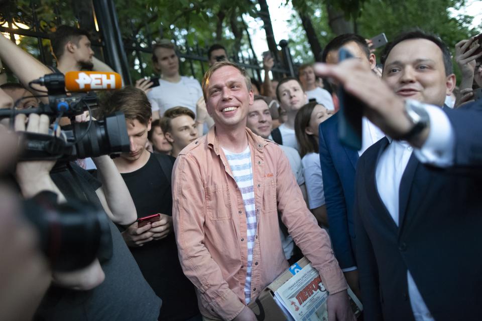 Prominent Russian investigative journalist Ivan Golunov, centre, smiles as he leaves a Investigative Committee building in Moscow, Russia, Tuesday, June 11, 2019. In a surprising turnaround, Russia's police chief on Tuesday dropped all charges against a prominent investigative reporter whose detention sparked public outrage and promised to go after the police officers who tried to frame the journalist as a drug-dealer. (AP Photo/Alexander Zemlianichenko)