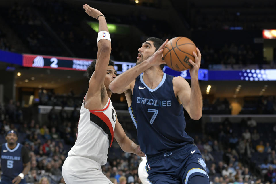 Memphis Grizzlies forward Santi Aldama (7) handles the ball against Portland Trail Blazers forward Toumani Camara, front left, in the first half of an NBA basketball game Friday, March 1, 2024, in Memphis, Tenn. (AP Photo/Brandon Dill)