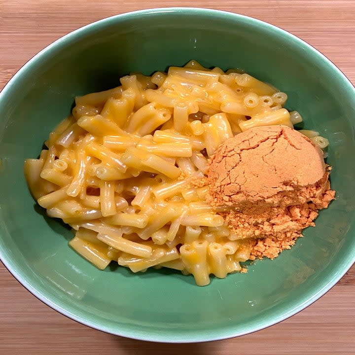 The bowl of mac n cheese with the buffalo powder sitting on top
