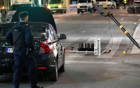 A run down traffic sign for 'Drottninggatan' is seen inside the roped off area outside the department store Ahlens after a suspected terror attack on the on the pedestrian street Drottninggatan in central Stockholm, Sweden, April 8, 2017. Maja Suslin/TT News Agency/via Reuters