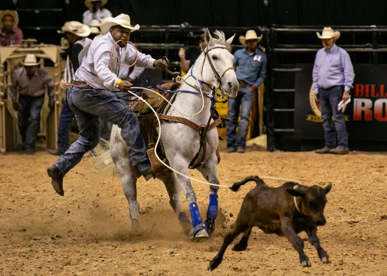 LAS VEGAS, CA - JUNE 13: A cowboy participates in the calf roping competition at the Bill Pickett Invitational Rodeo on Sunday, June 13, 2021 in Las Vegas, CA. (Jason Armond / Los Angeles Times)