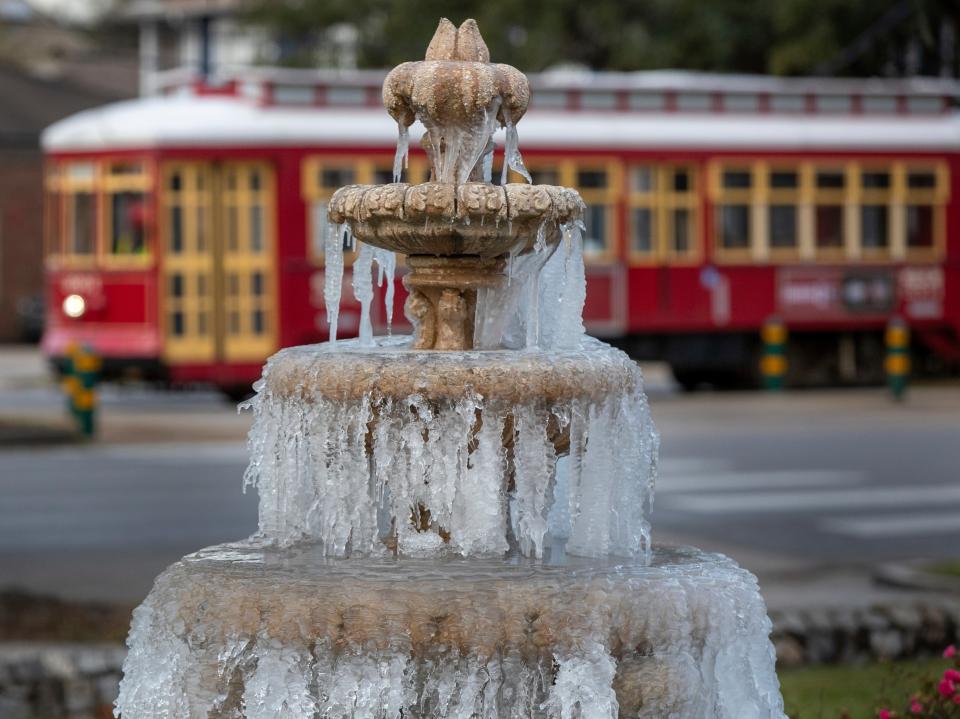 The fountain is frozen as temperatures hovered in the mid 20's at Jacob Schoen & Son Funeral Home in New Orleans, Saturday, Dec. 24, 2022 (AP)