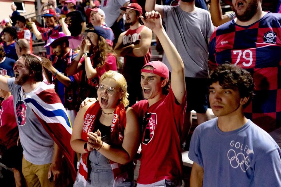 Ethan Akenbrandt, 20, of St. Charles, Missouri, center, cheers on St. Louis City 2 alongside Em Brunson, 22, of Warrenton, Missouri, left, on Aug. 6 during a matchup against Chicago Fire 2 at Ralph Korte Stadium in Edwardsville.