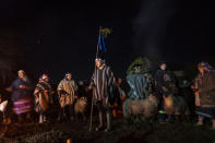 Community members prepare to sacrifice lambs in commemoration of We Tripantu, the Mapuche new year, in the Corayen community of Los Rios, southern Chile, on Tuesday, June 21, 2022. (AP Photo/Rodrigo Abd)