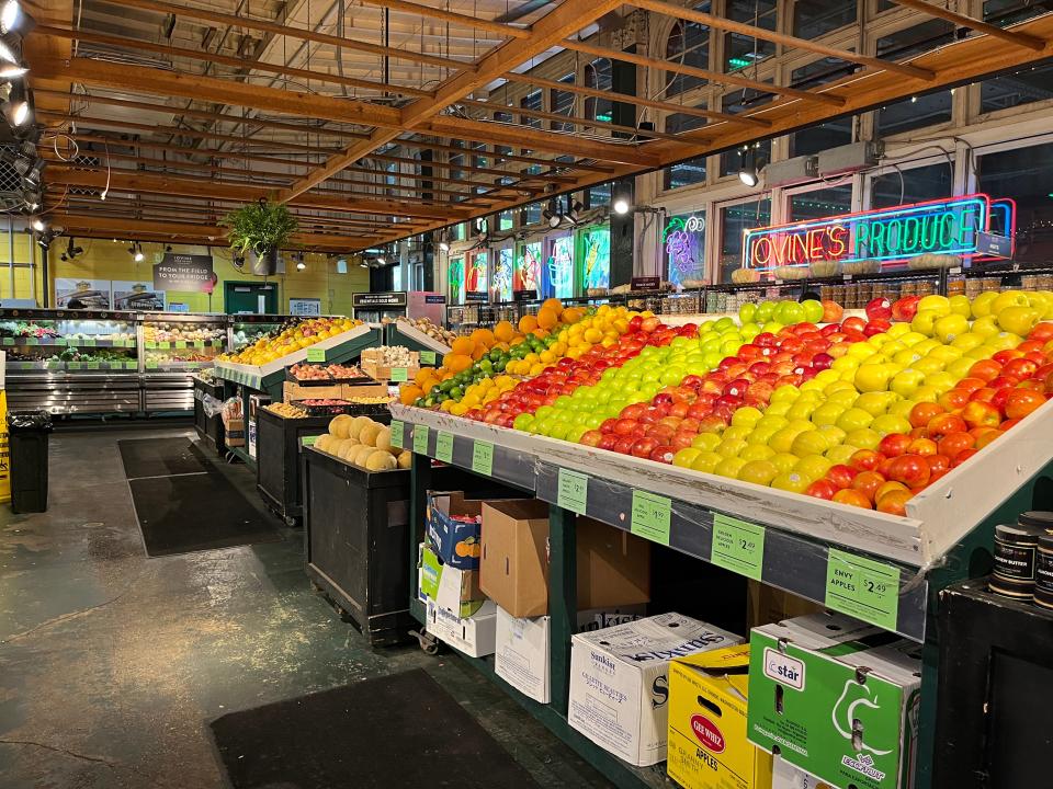 Rows of colorful produce at a grocery booth in the Reading Terminal Market