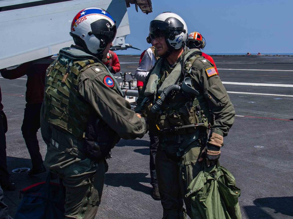 Capt. Craig Sicola and Cmdr. Luke Edwards shake hands after making the landing.