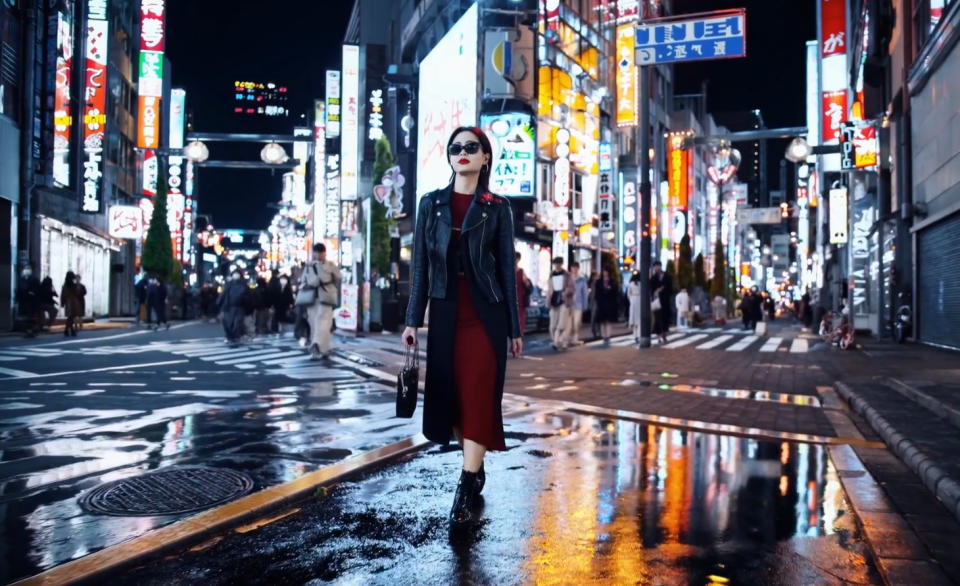 A still from an AI generated video of a woman in Tokyo at night.