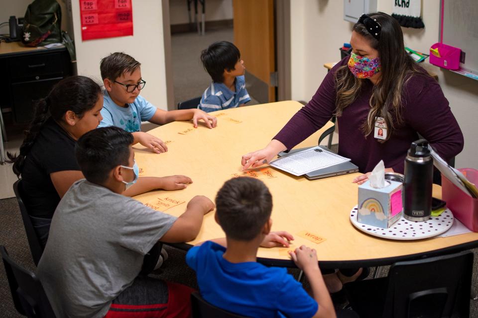 Teacher Caitlin Bruen leads a group through sight words during an intensive reading class at Freedom Elementary School in Buckeye, Arizona, on Nov. 16, 2021.