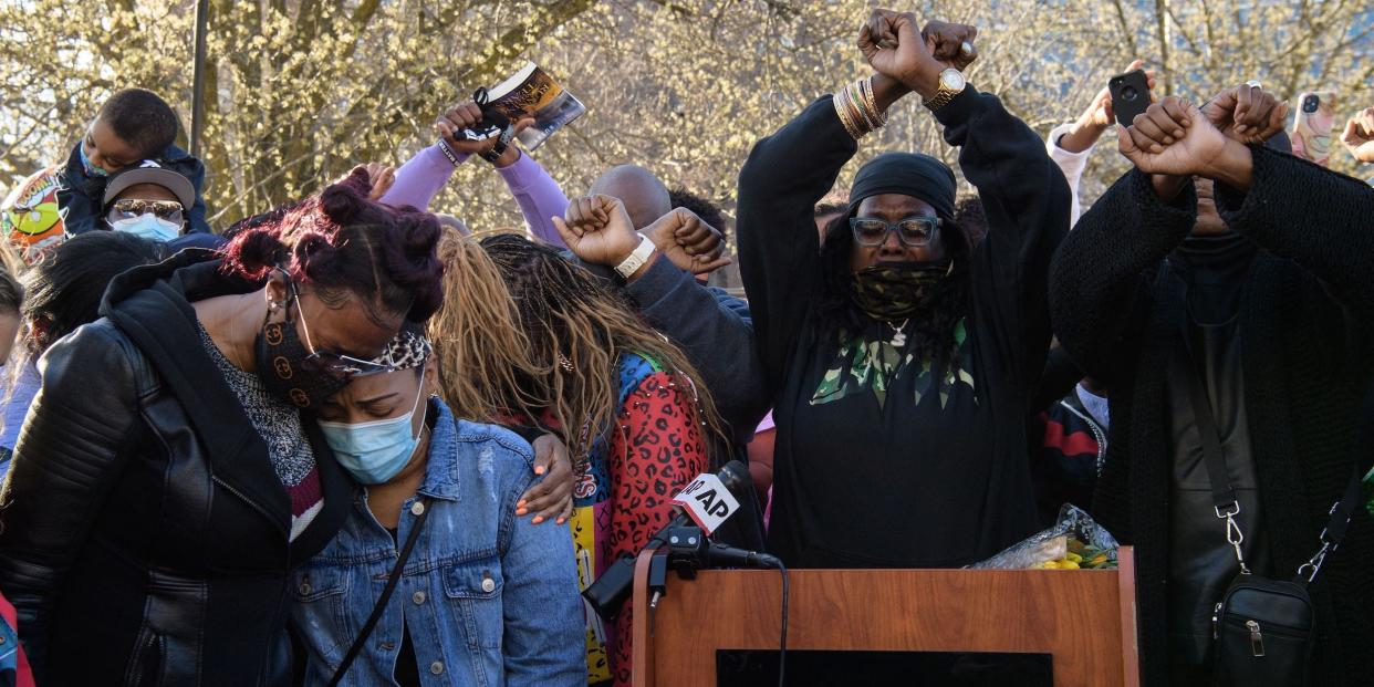 Ex-wife Tashera Simmons (L) and fiancee Desiree Lindstrom (2L) hug while surrounded by friends of hospitalized rapper Earl Simmons, aka DMX, attend a prayer vigil hosted by the Ruff Ryders to the Rescue Foundation at White Plains Hospital on April 5, 2021 in White Plains, New York.