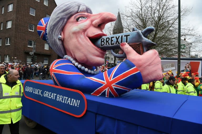 A carnival float depicting British Prime Minister Theresa May pointing a gun to her with the lettering "Brexit" takes part in the traditional "Rose Monday" carnival parade in Duesseldorf, western Germany on February 27, 2017