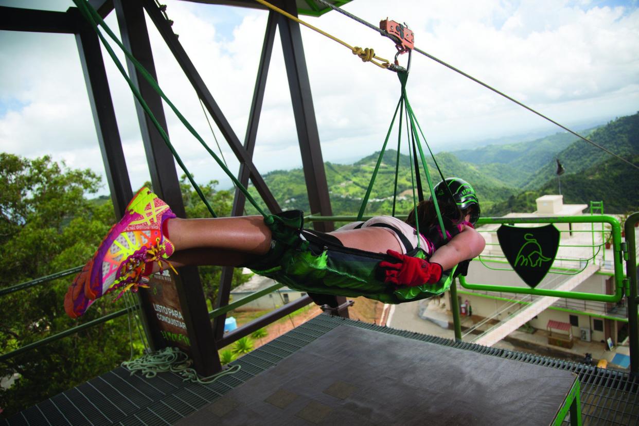 woman strapped into el monstruo zipline about to descent