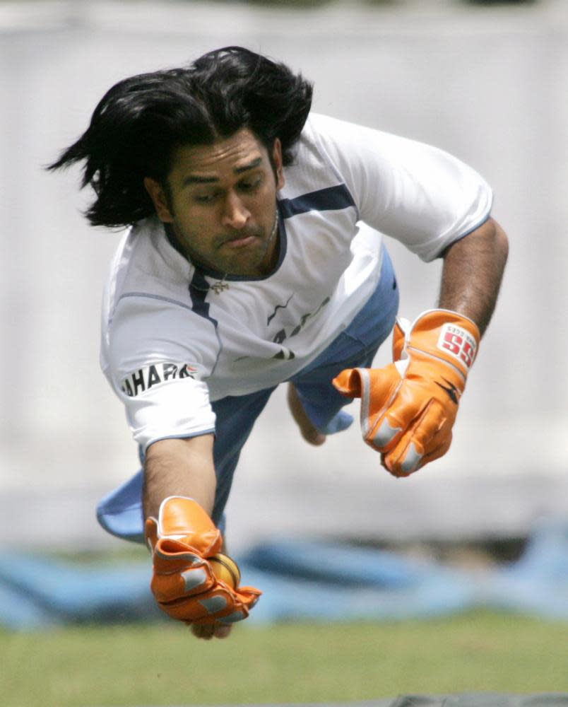 MS Dhoni dives to take a catch during a practice session in Bangalore in September 2006