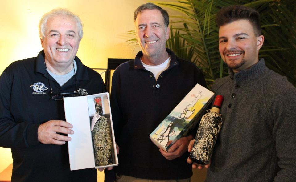 Wine of the Sea owner Zarko Bogojevic, from left, partner Nick Wood and Director of Business Development Max Hansen hold coral-encrusted Wine of the Sea bottles, which are aged under the Adriatic Sea for up to two years.