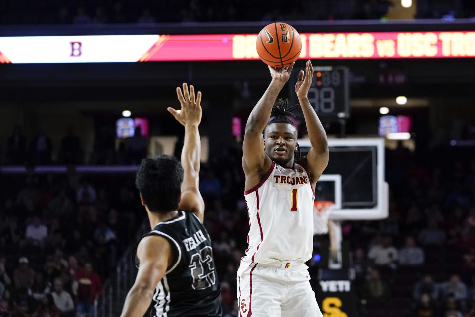 Southern California guard Isaiah Collier, right, shoots against Brown guard Kimo Ferrari during the first half of an NCAA college basketball game, Sunday, Nov. 19, 2023, in Los Angeles. (AP Photo/Ryan Sun)