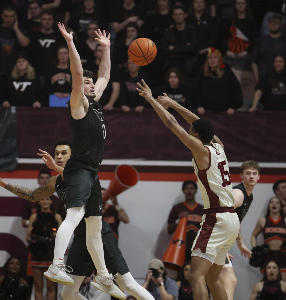 Virginia Tech's Hunter Cattoor (0) blocks a pass by Boston College's Jack Di Donna (15) during the second half of an NCAA college basketball game Tuesday, Jan. 23, 2024, in Blacksburg, Va. (Matt Gentry/The Roanoke Times via AP)