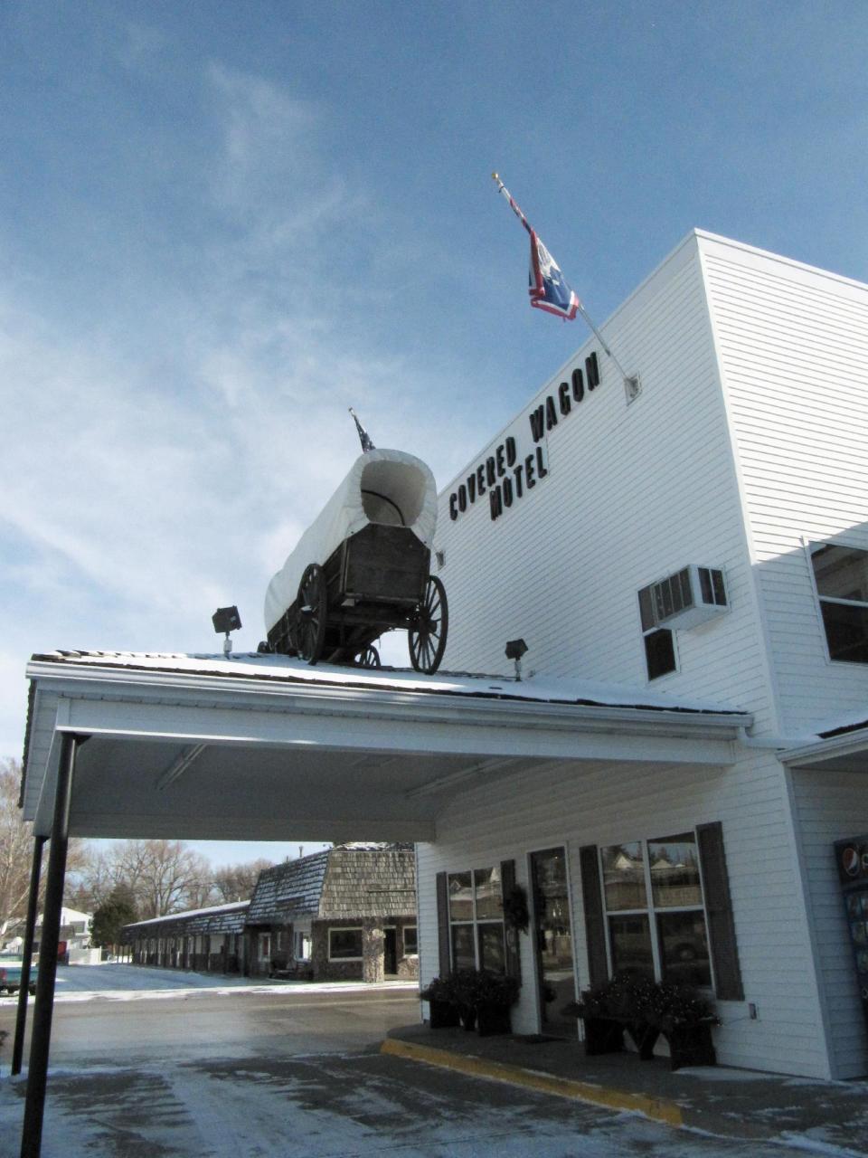 This Jan. 2, 2014 photo shows the Covered Wagon Motel in Lusk, Wyo., where electric car manufacturer Tesla installed four of its Supercharger units in the courtyard in December, 2013. A Supercharger can recharge a Tesla's depleted battery pack to a 90-percent level within 45-50 minutes, several times faster than any other charging option for the electric cars. Lusk is on the route of Tesla's first network of coast-to-coast Supercharger stations. The quick-charge stations promise to make cross-country travel by Tesla much quicker and easier. (AP Photo/Mead Gruver)