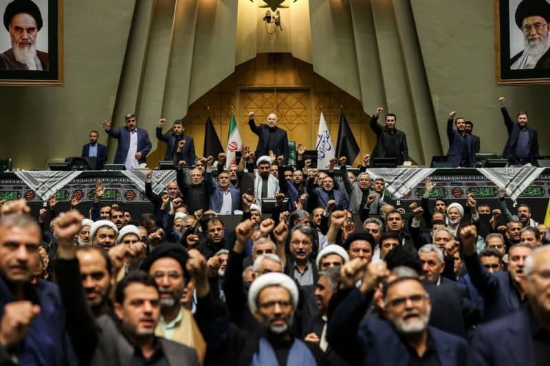 Iranian lawmakers chant anti-Isreal slogans during a closed session of the Iranian Parliament in Tehran. The Lebanese militant group Hezbollah confirmed that its leader, Hassan Nasrallah, was killed in an Israeli military strike on the group's central headquarters in Beirut on 27 September 2024. Iran condemned the Israeli strikes on Lebanon. Icana News Agency/ZUMA Press Wire/dpa