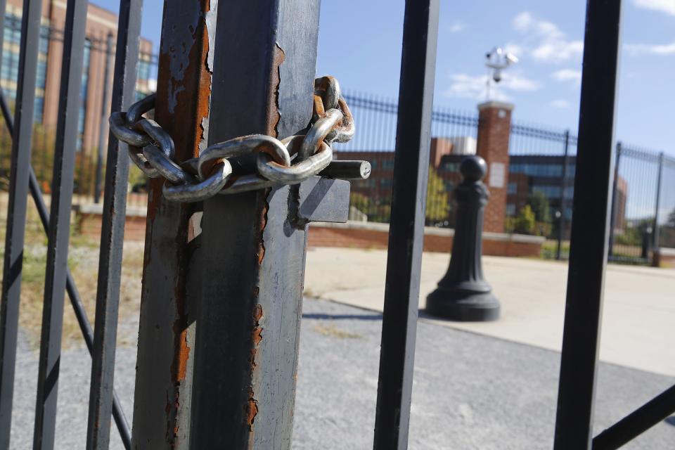 Locked gates secure a pedestrian walkway along the Anacostia River at the Navy Yard installation the day after a shooting rampage, in Washington