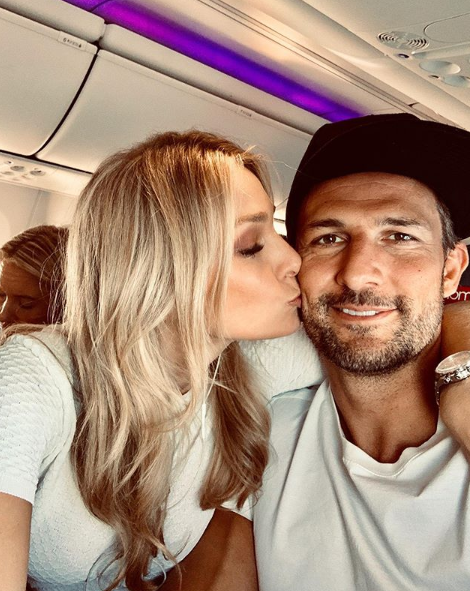 A photo of Tim Robards and Anna Heinrich on a plane.