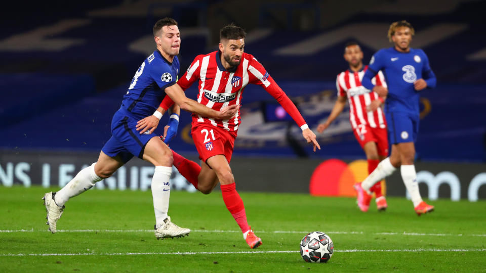 Yannick Ferreira Carrasco goes down after a challenge by Cesar Azpilicueta during the UEFA Champions League Round of 16 match.