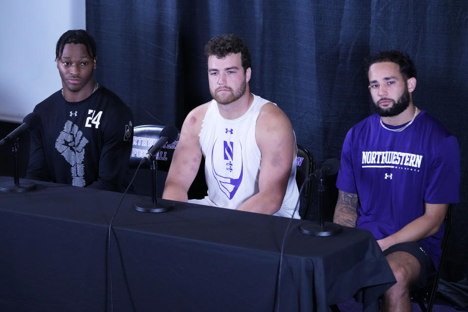 Northwestern safety Rod Heard II, left, linebacker Bryce Gallagher, center, and wide receiver Bryce Kirtz listen to a question during a news conference at Walter Athletics Center in Evanston, Ill., Wednesday, Aug. 9, 2023. (AP Photo/Nam Y. Huh)