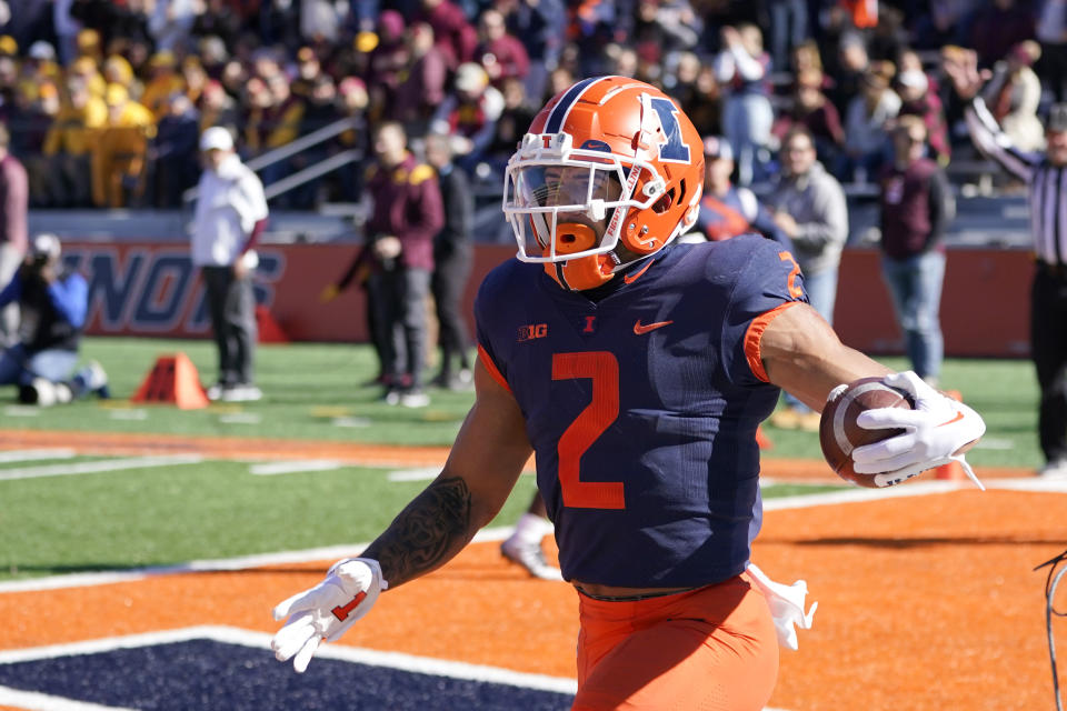 Illinois running back Chase Brown celebrates his touchdown off a pass from quarterback Tommy DeVito during the first half of an NCAA college football game against the Minnesota, Saturday, Oct. 15, 2022, in Champaign, Ill. (AP Photo/Charles Rex Arbogast)